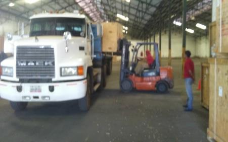 Truck and forklift loading materials at a warehouse