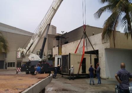 Personnel and crane positioning a generator